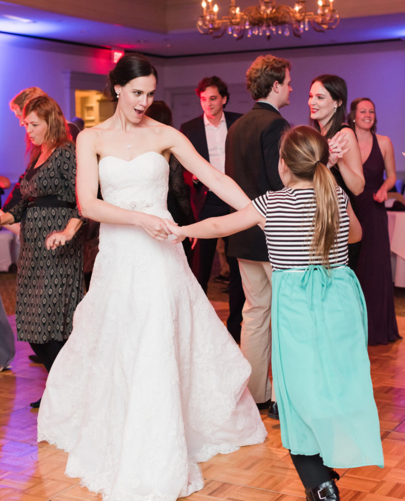 bride and child dancing to a wedding dj on the dance floor