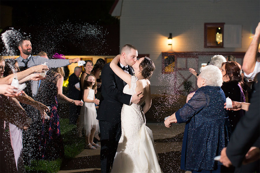 Couple Kissing while exiting wedding