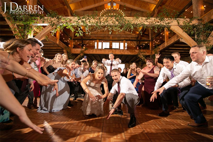 The bride, groom, and their family and friends dancing. 