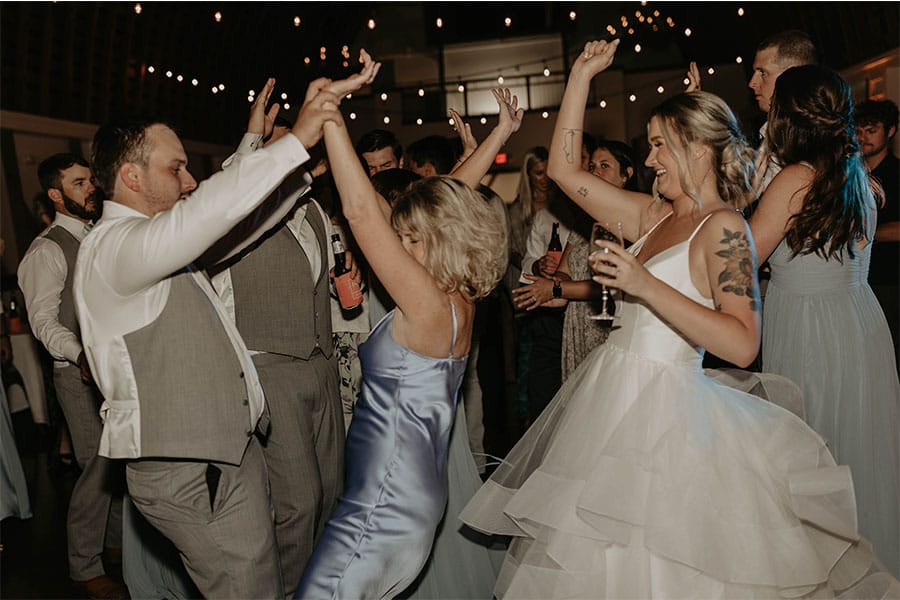 The bride and grooms friends and family dancing.