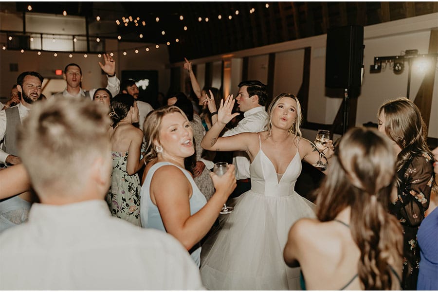 The bride and grooms friends and family dancing. 