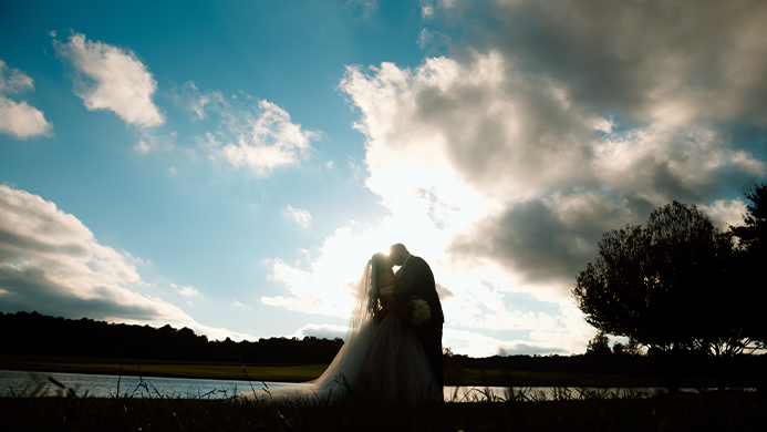 A beautiful picture of the bride and groom kissing.