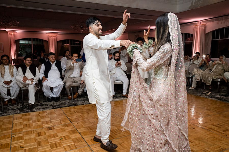 The bride and groom dancing together.