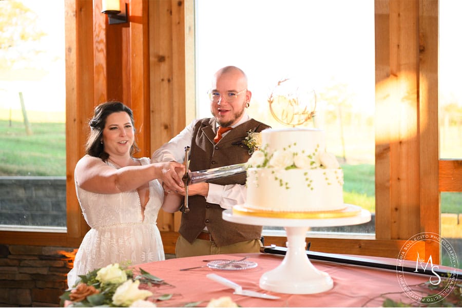 The bride and groom cutting their cake.