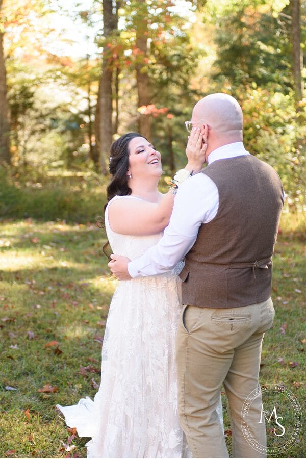 The bride and groom in front of beautiful woods.