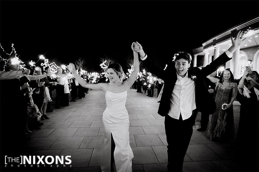 The bride and groom leaving their wedding. 