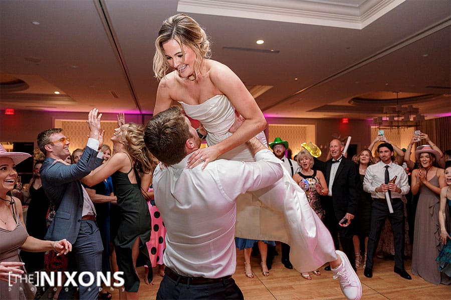 The groom lifting up the bride. 