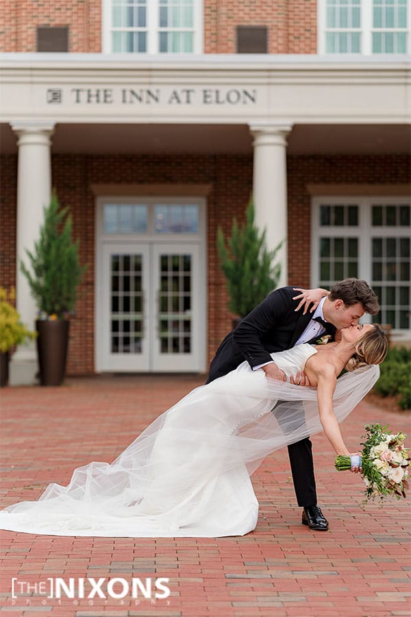 The bride and groom kissing.