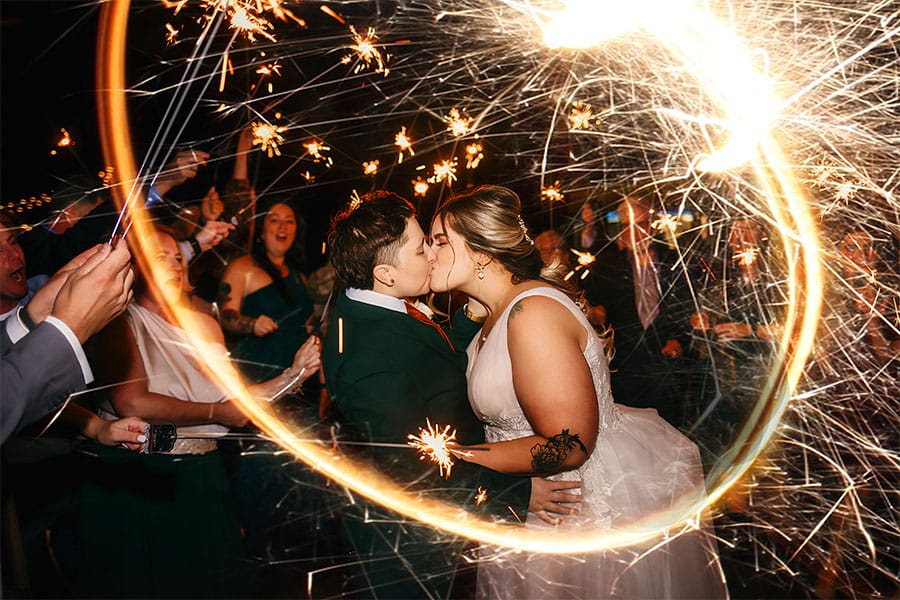 the brides kissing with lights around the.