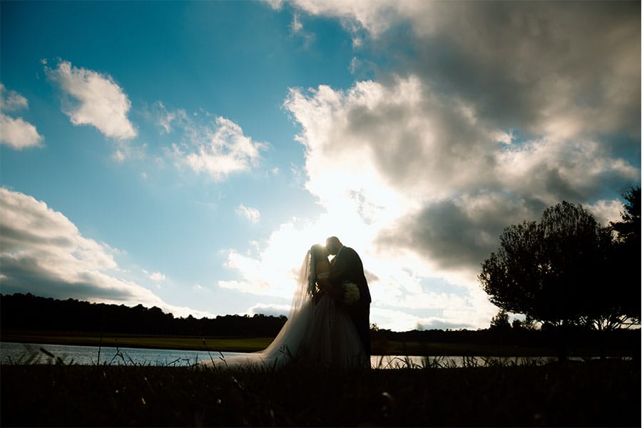 A beautiful picture of the bride and groom kissing.