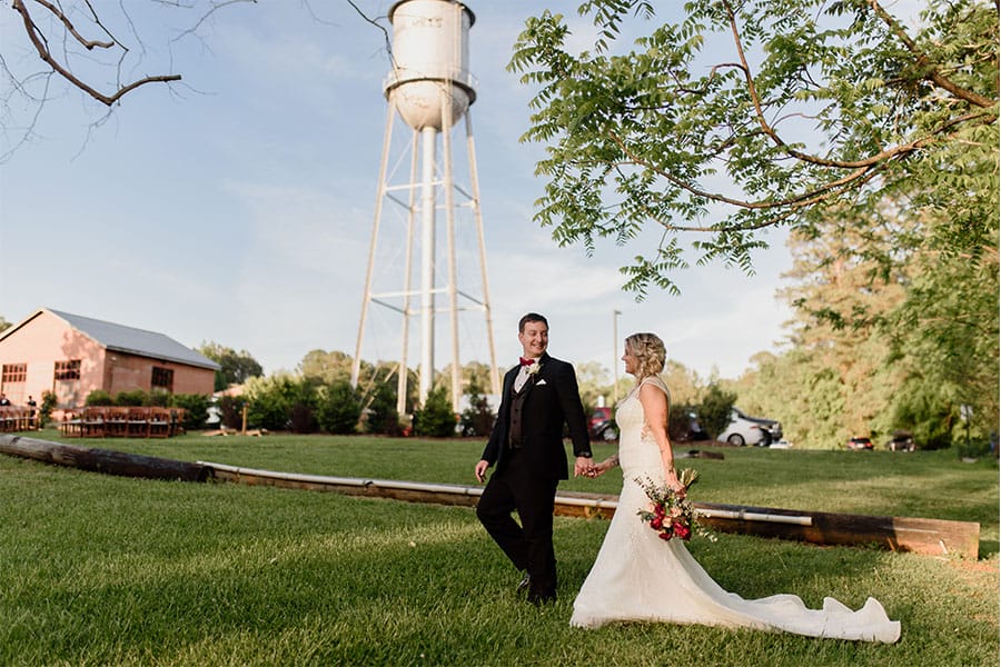 The bride and groom holding hands. 