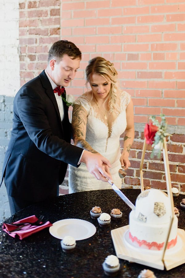 The bride and groom cutting the cake. 