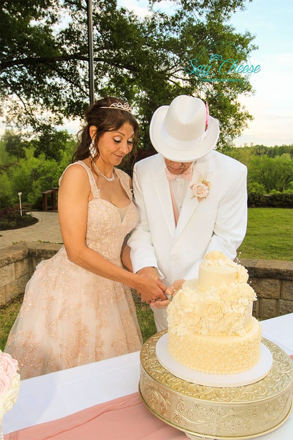 The bride and groom cutting the cake. 