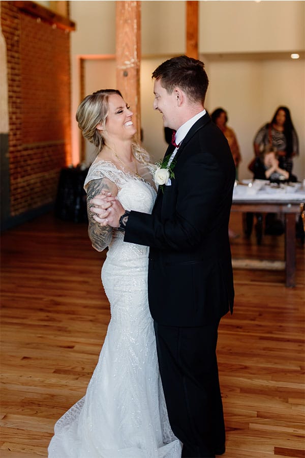 The bride and groom dancing together. 