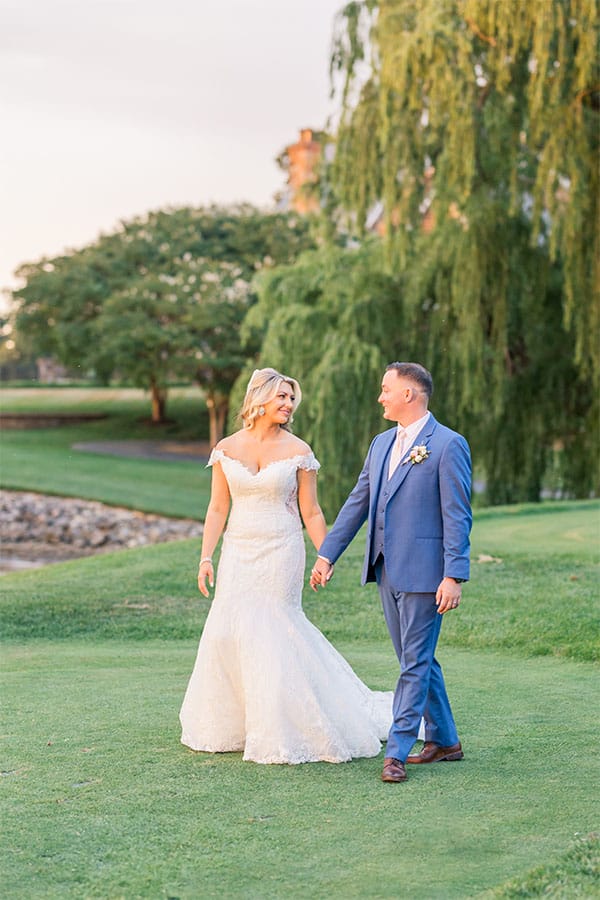 The bride and groom walking together. 