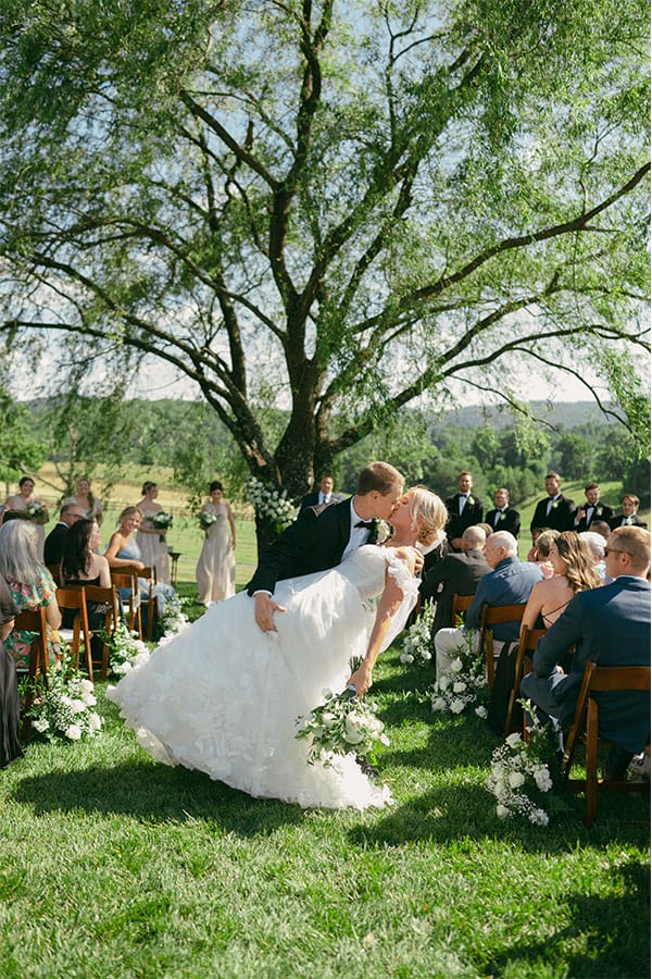 The bride and groom kissing.