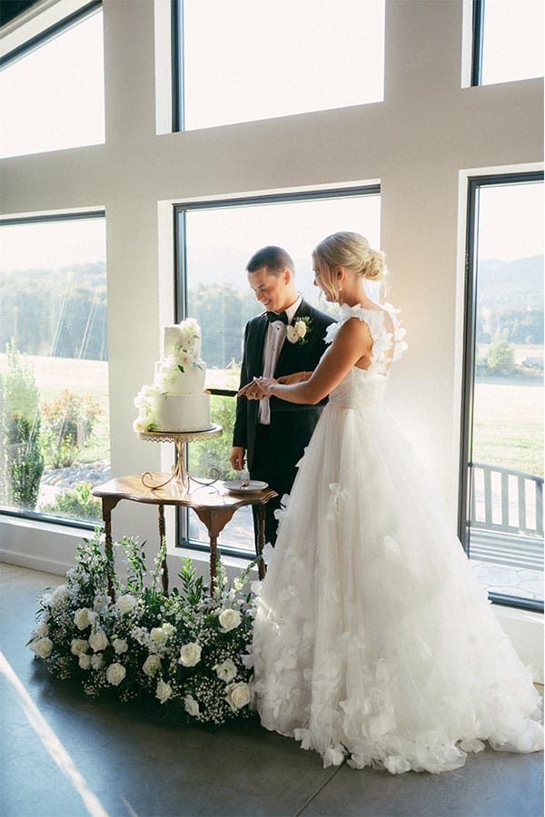 The bride and groom cutting their wedding cake.