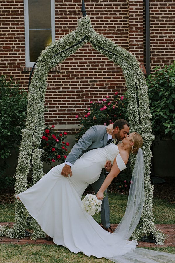 The bride and groom kissing.