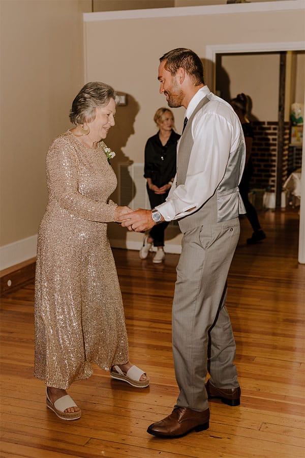 The groom dancing with some one. 