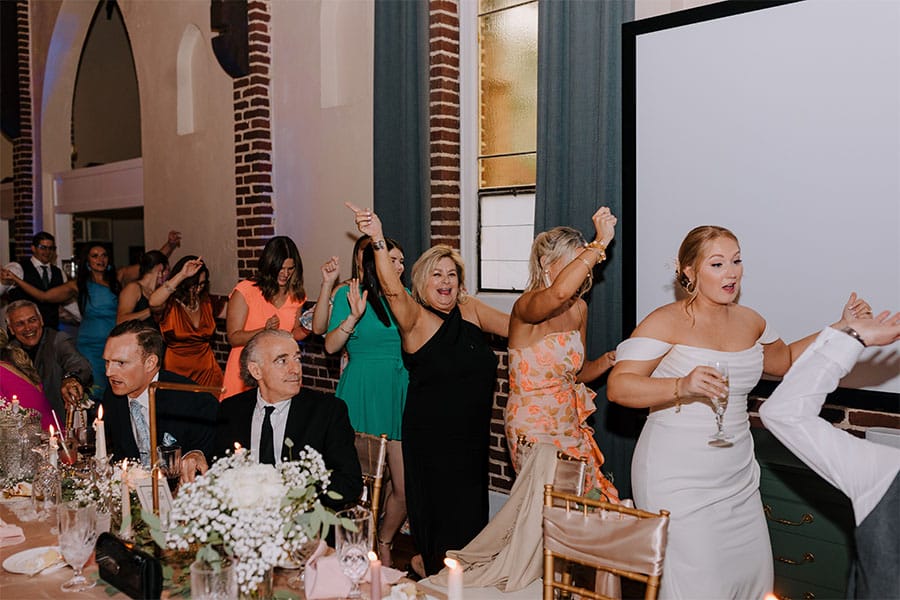 The couples family and friends dancing. 