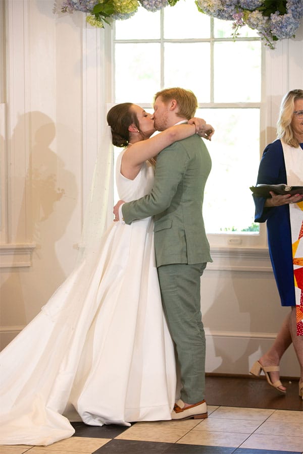 The bride and groom kissing.