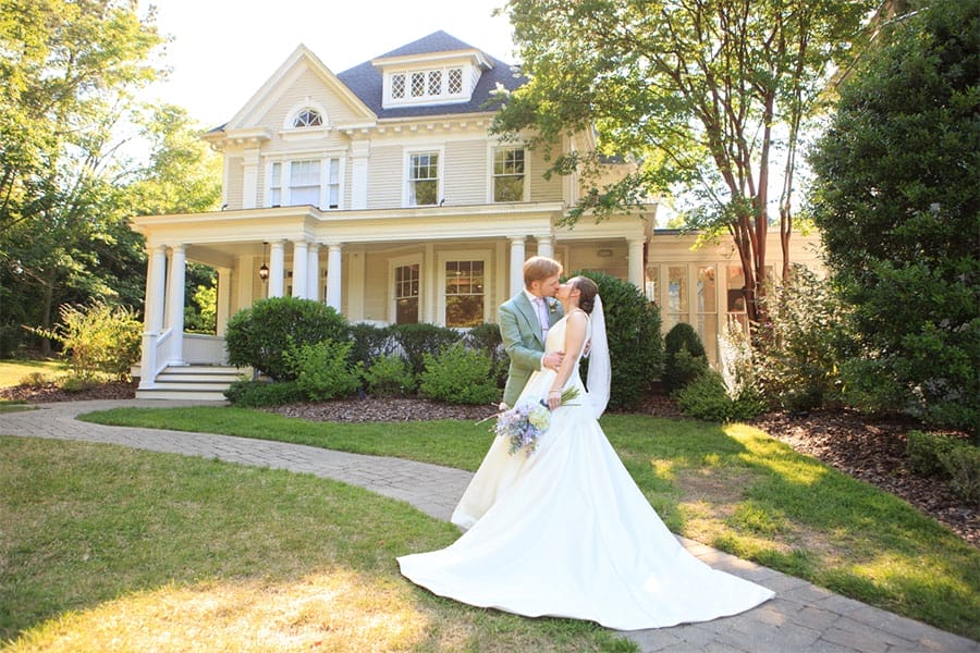 The bride and groom kissing.