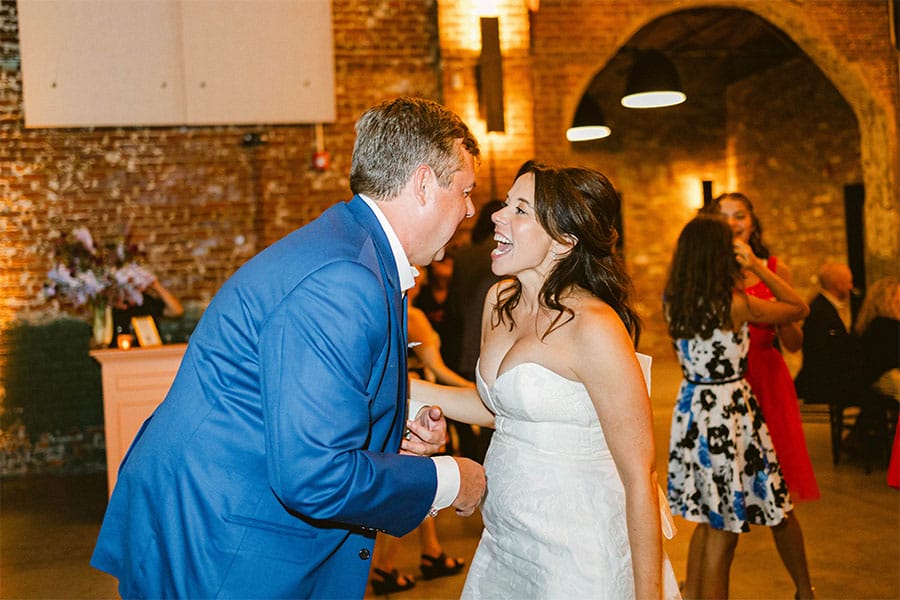 The bride and groom dancing and singing together.