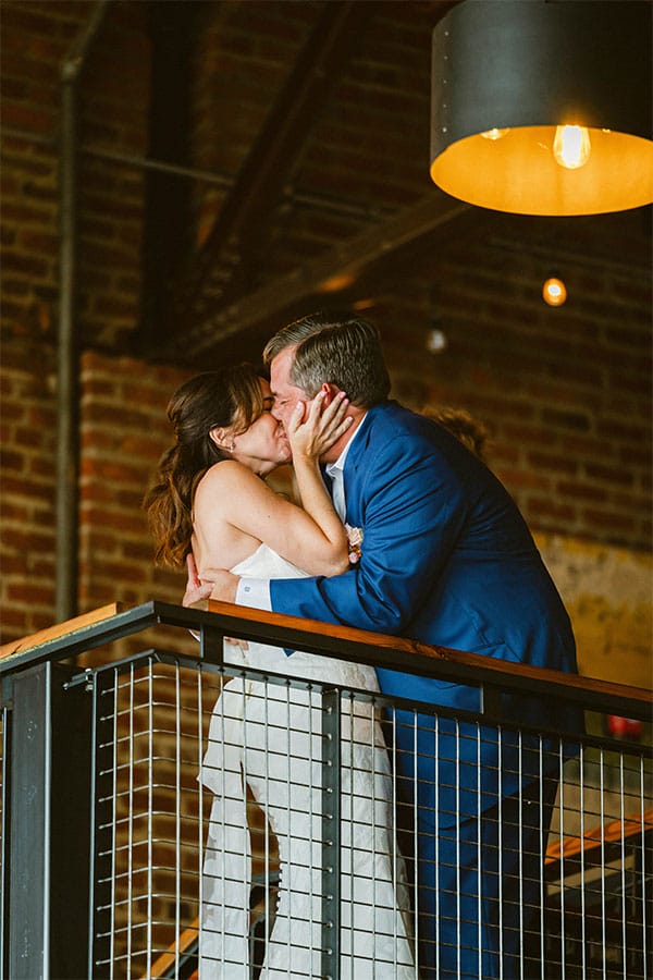 The bride and groom kissing.