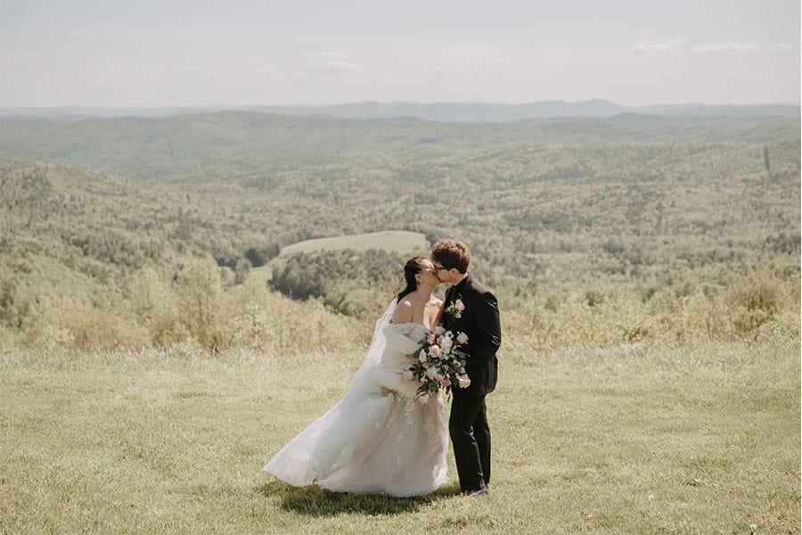 The bride and groom kissing.