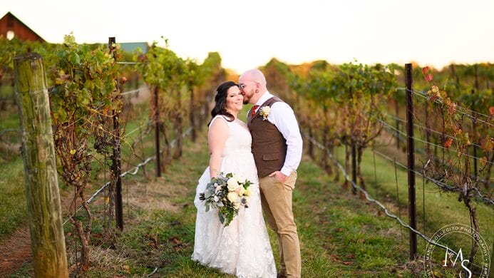 The bride and groom in a orchard.