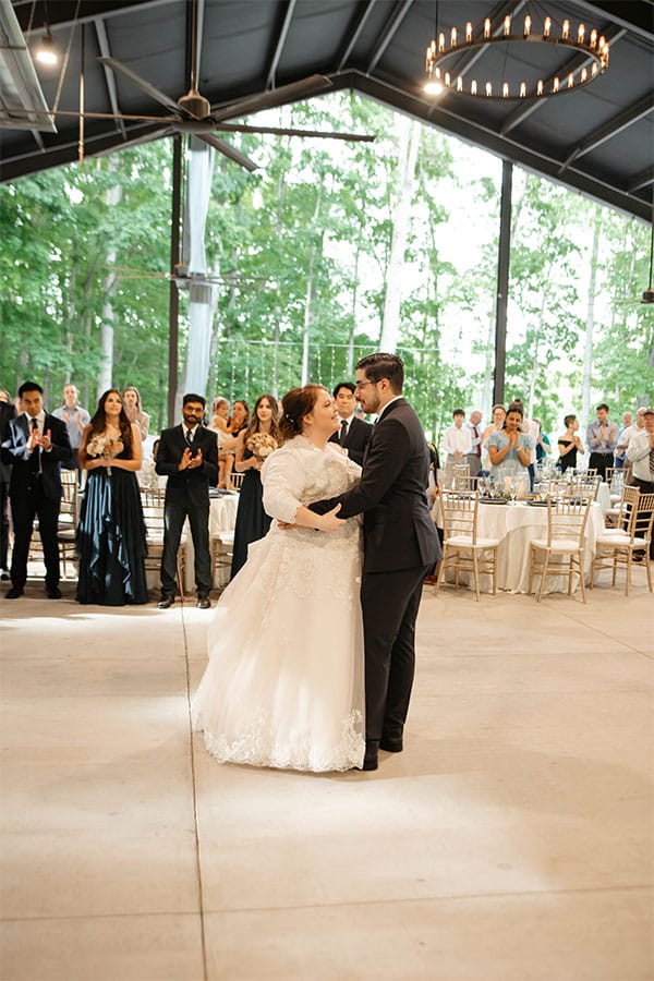 The bride and groom dancing together. 
