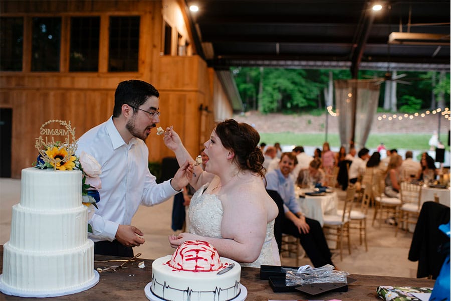 The bride and groom cutting their cake. 
