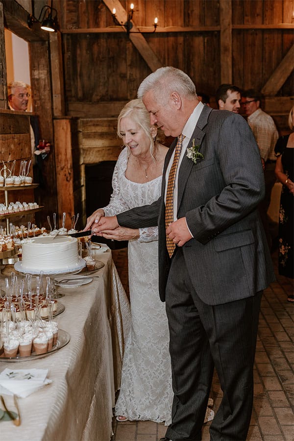 The bride and groom cutting there wedding cake.