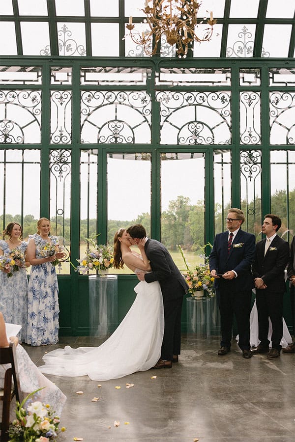 The bride and groom kissing at the alter.