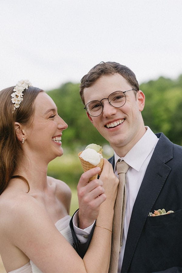 The bride and groom holding ice cream.