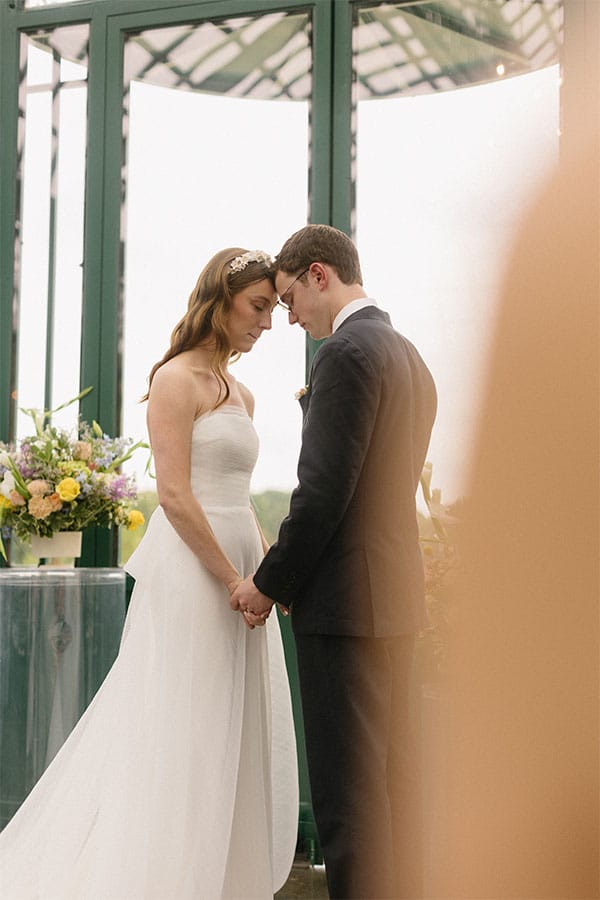 The bride and groom standing face to face.