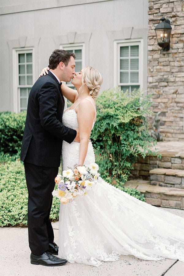 The bride and groom kissing.