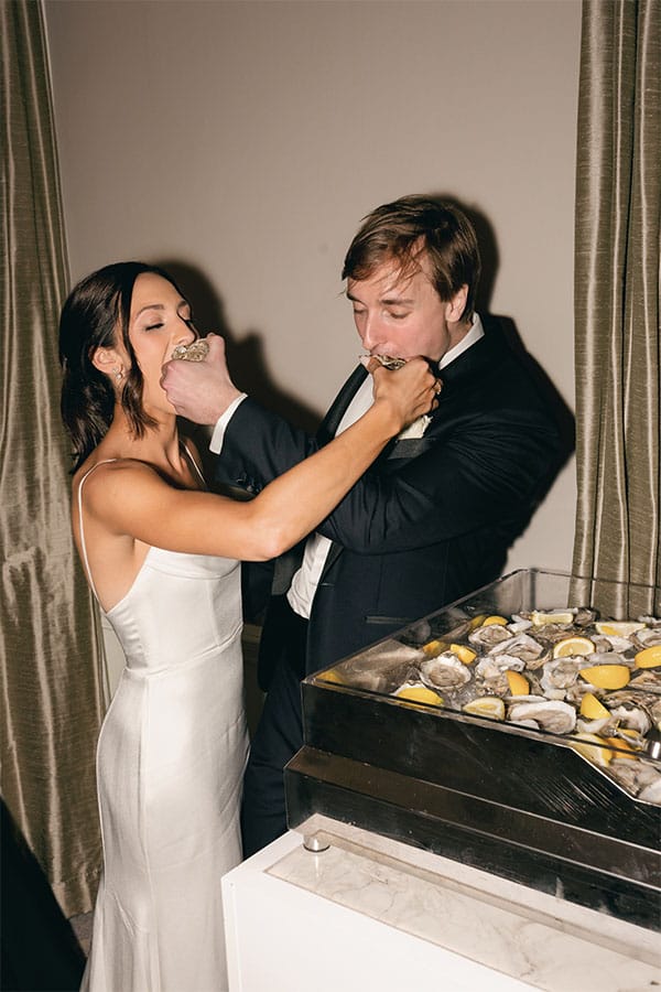 The bride and groom eating their wedding cake. 