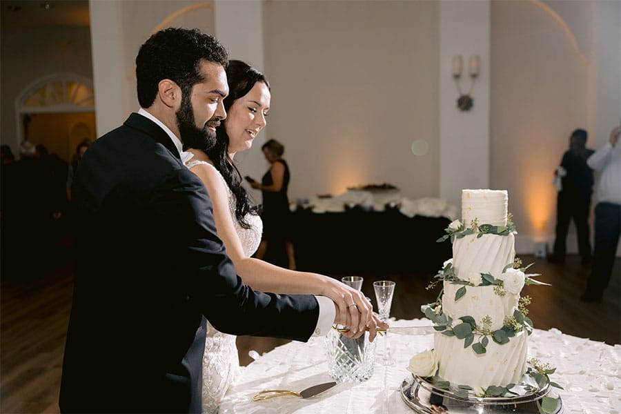 The bride and groom cutting there wedding cake.