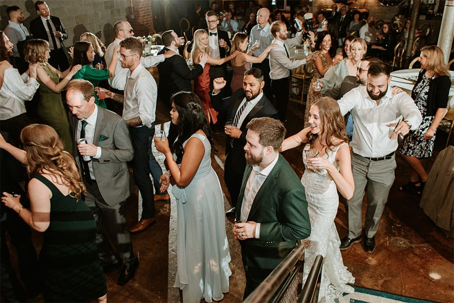 The couples loved ones celebrating the marriage by dancing. 