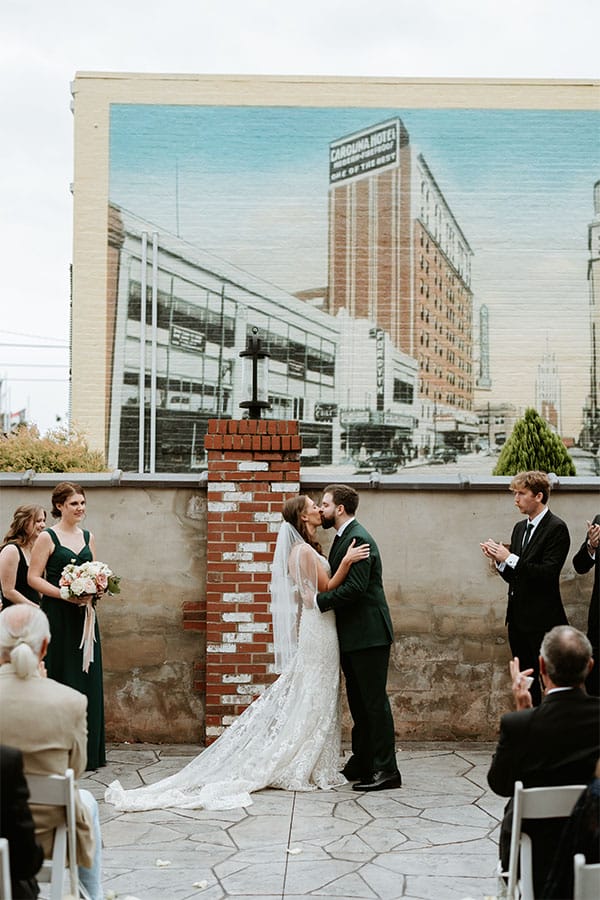 The bride and groom kissing. 