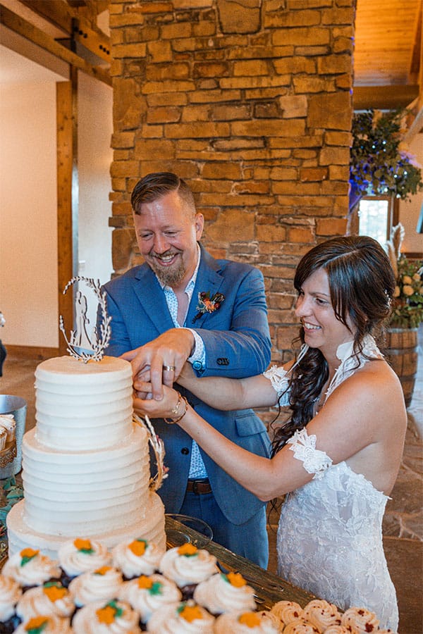 The bride and groom cutting cake.