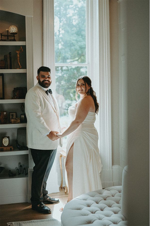 The bride and groom holding hands. 