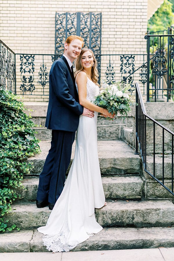 The bride and groom on a stair case. 