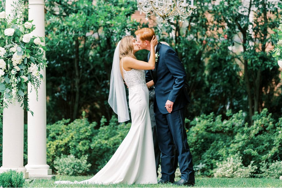 The bride and groom kissing. 