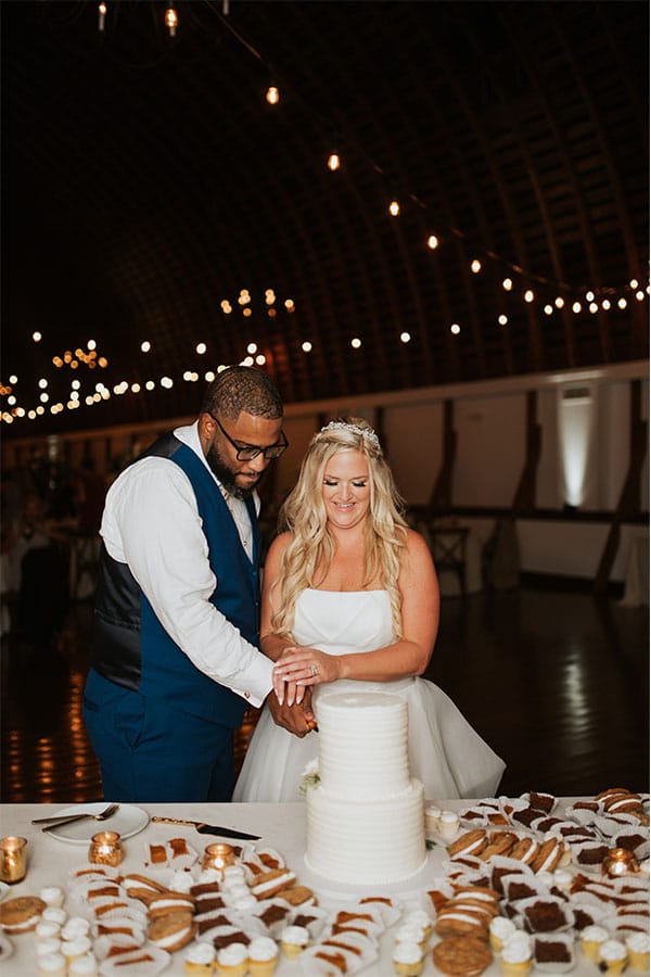 The couple cutting their wedding cake. 