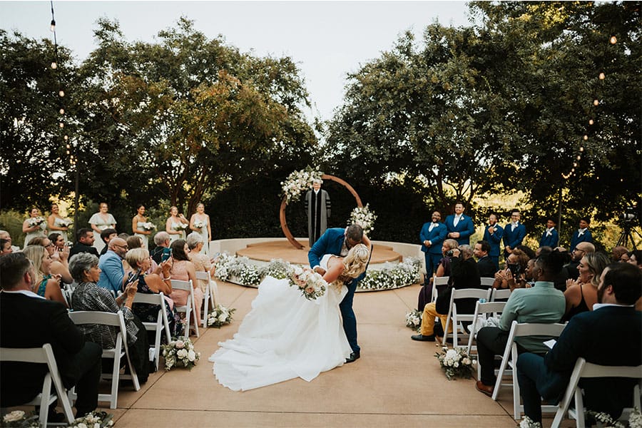 The bride and groom kissing at the alter.