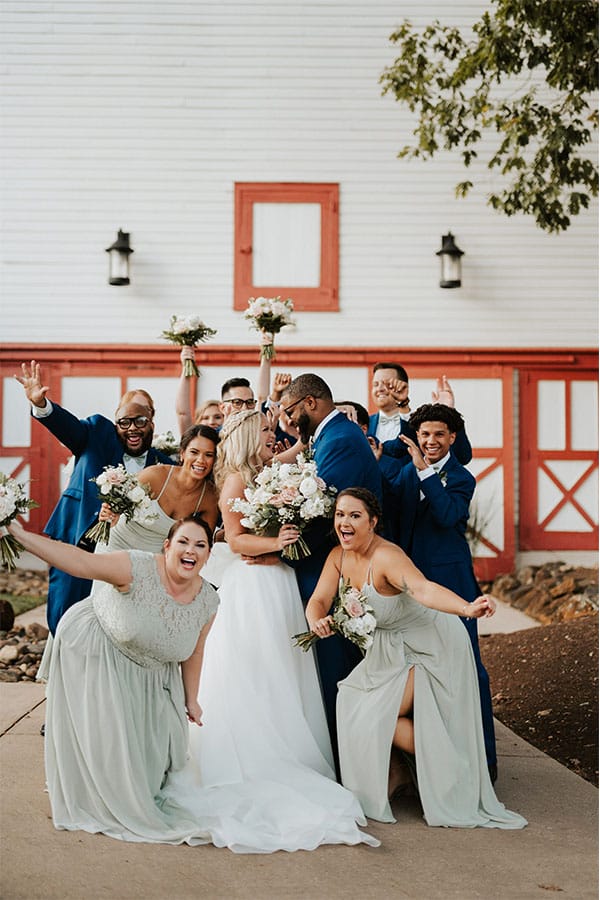 The couple with their bridesmaids and groomsmen around them. 