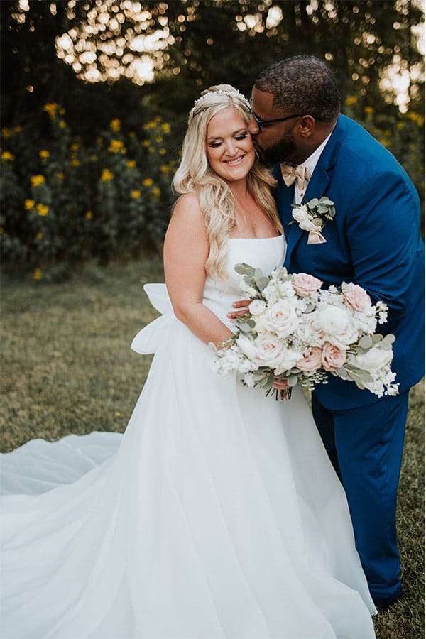 The groom kissing the bride.