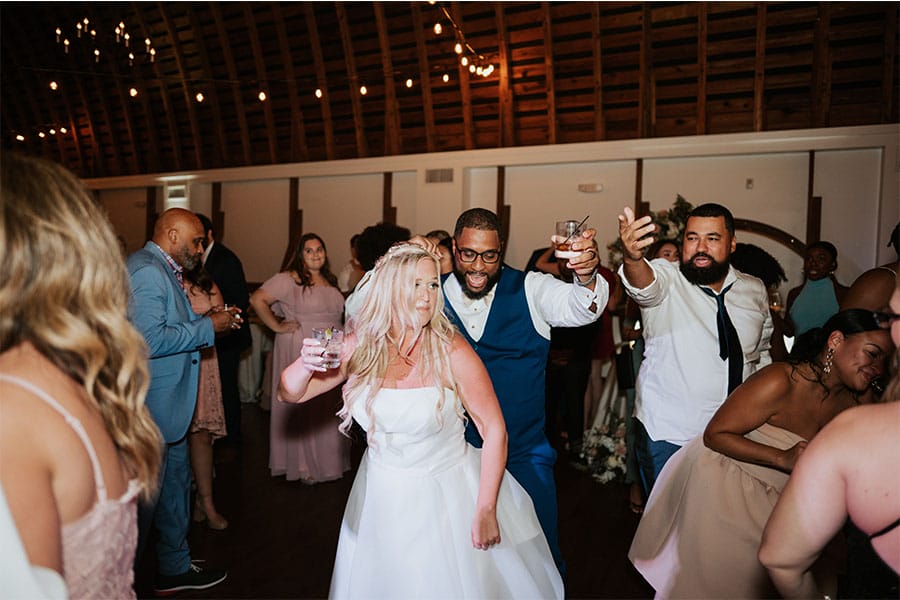 The bride and groom dancing with their friends and family. 